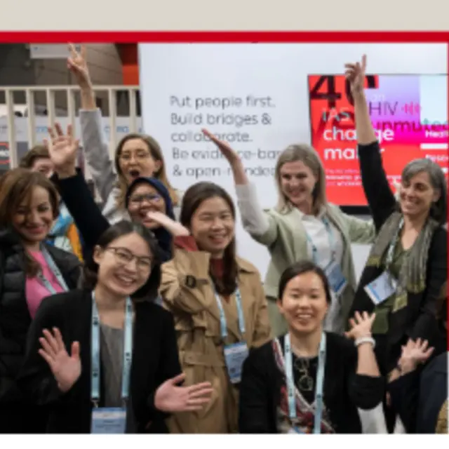 a group of women raising their hands