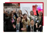 a group of women raising their hands